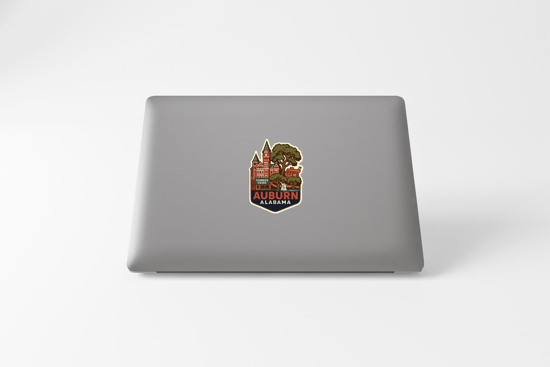 A sticker depicting a cityscape with a prominent tree in the center, surrounded by buildings and other urban elements.