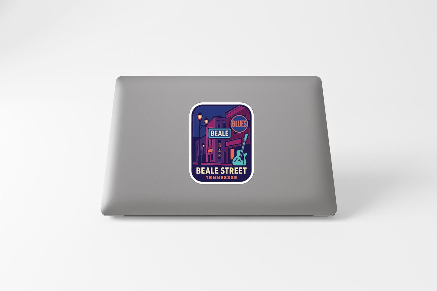 A sticker on the back of a laptop, depicting a colorful illustration of a building and the text "BEALE STREET TENNESSEE".