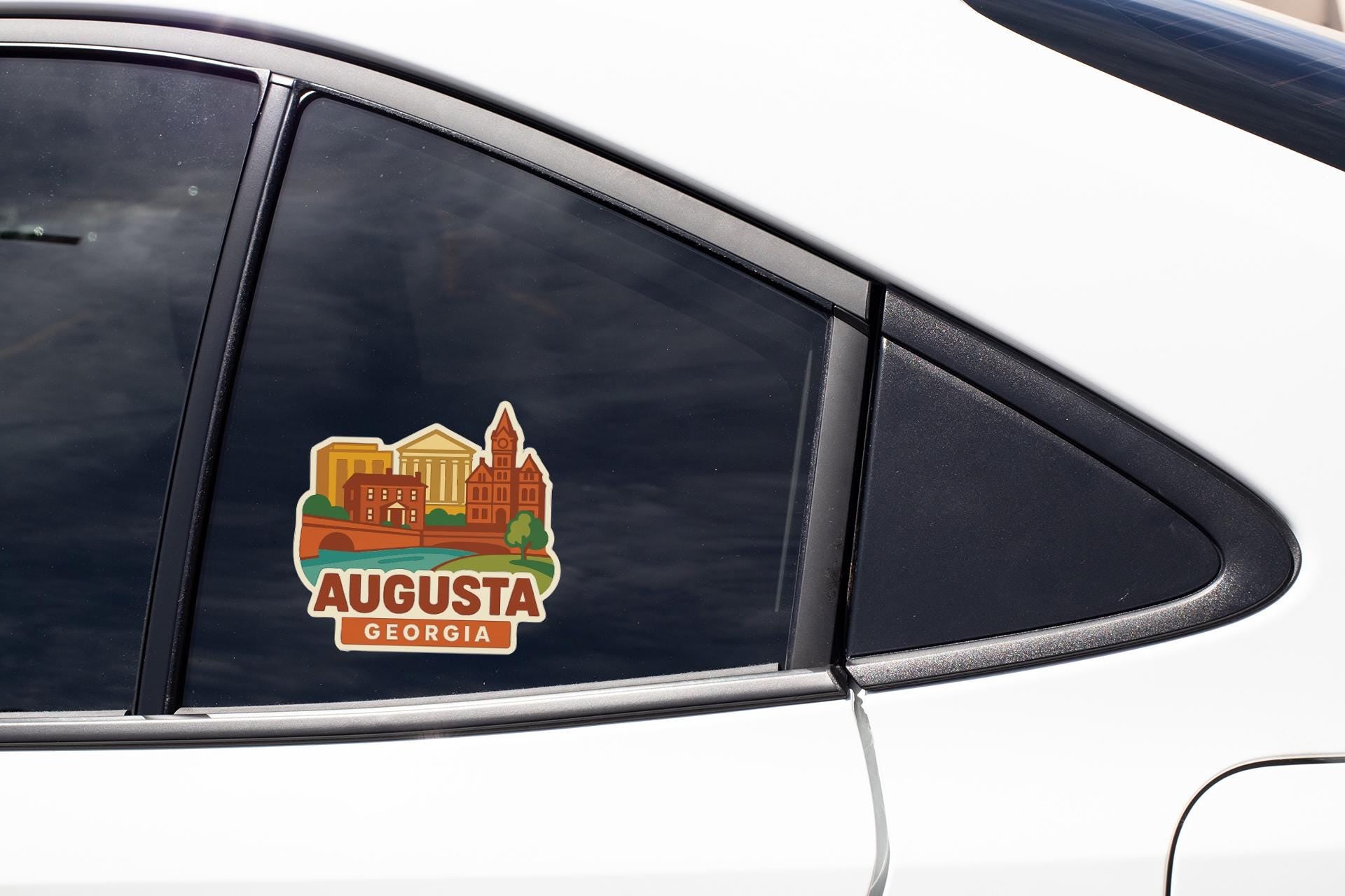 A sticker on the side of a car window, depicting a cityscape with buildings and a river, along with the text "AUGUSTA GEORGIA".