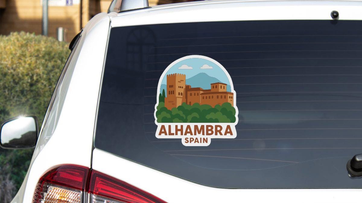 A sticker on the rear window of a car that features an illustration of Alhambra, Spain.