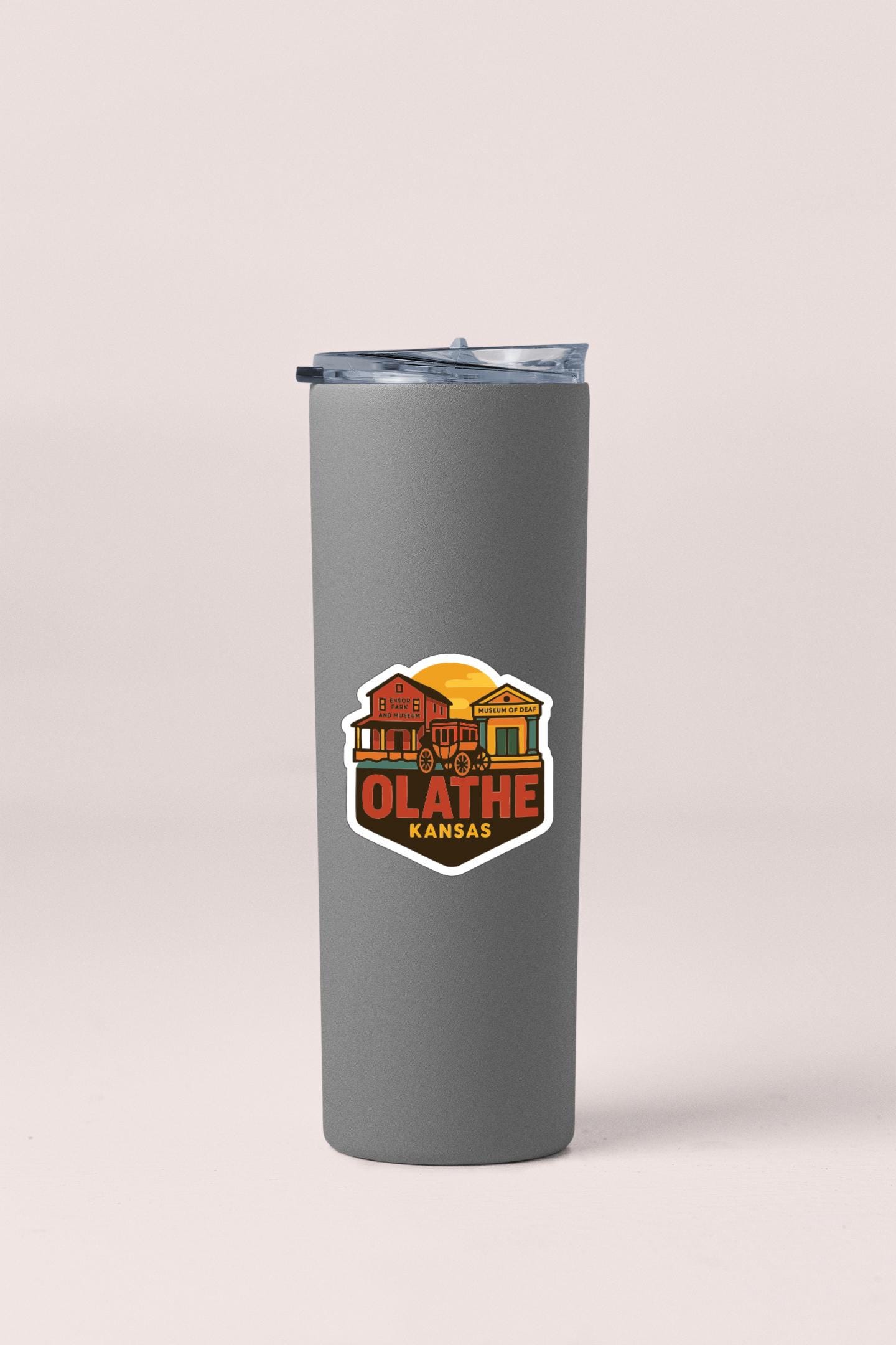 A gray insulated tumbler with a logo that says "OLATHE KANSAS" on it.