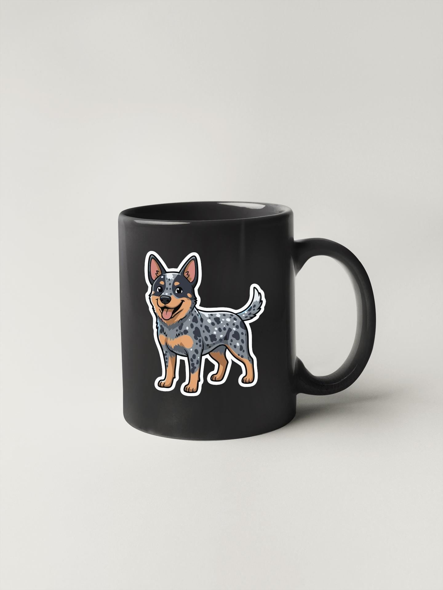 A black coffee mug with a cartoon illustration of a spotted dog on it.