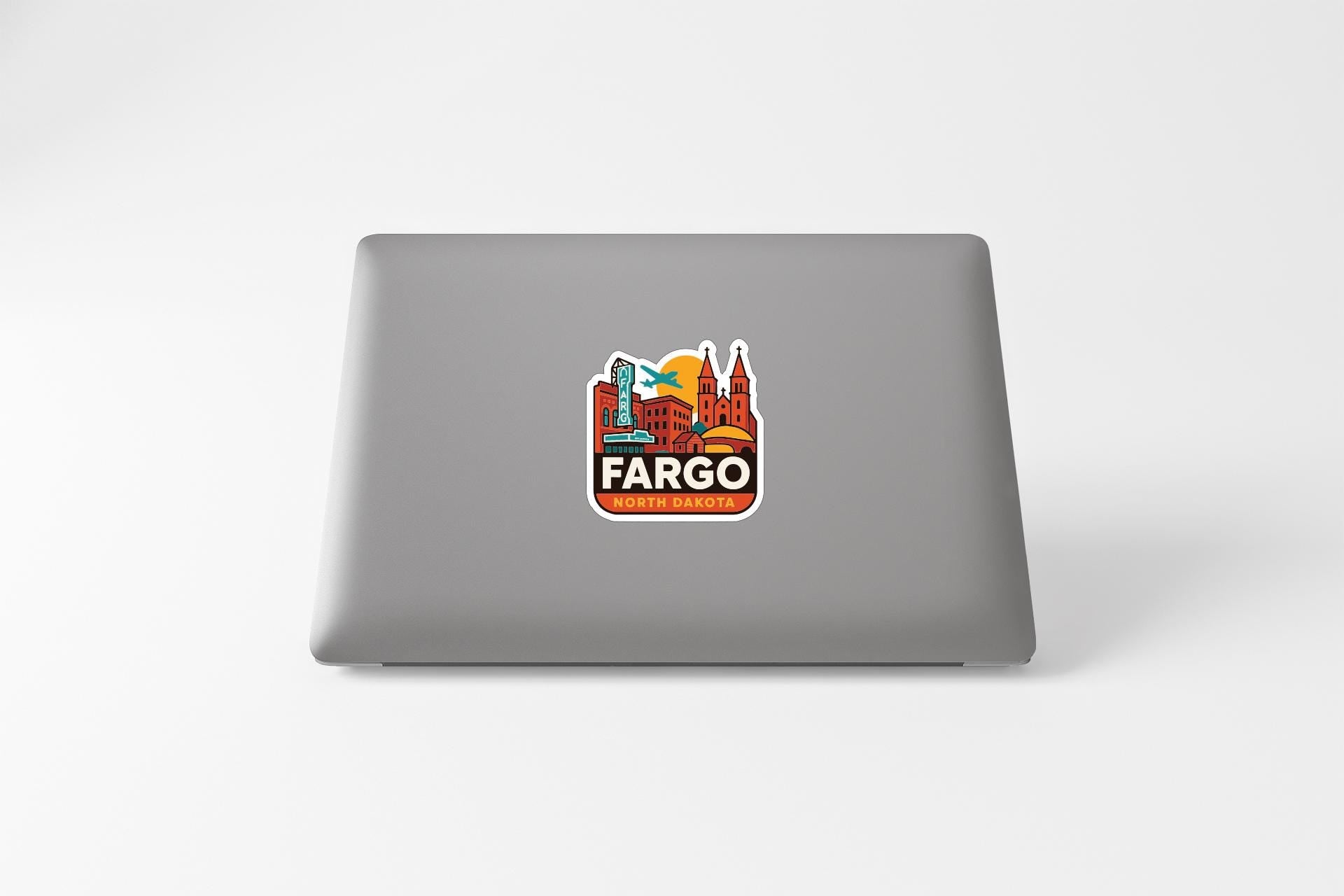 a sticker on the back of a laptop that says "FARGO" and "Dakota" in a stylized design.