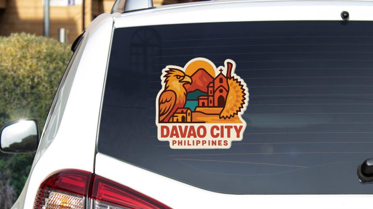 a sticker on the rear window of a car that says "DAVAO CITY PHILIPPINES".