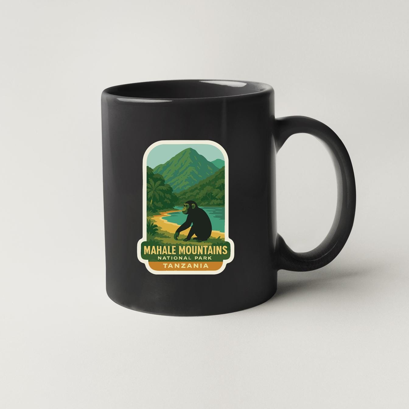 A black coffee mug with a label that says "Mahale Mountains National Park, Tanzania".