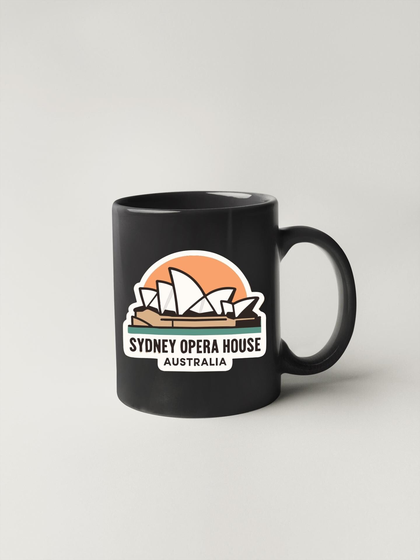 A black coffee mug with a graphic of the Sydney Opera House and the text "SYDNEY OPERA HOUSE AUSTRALIA" printed on it.