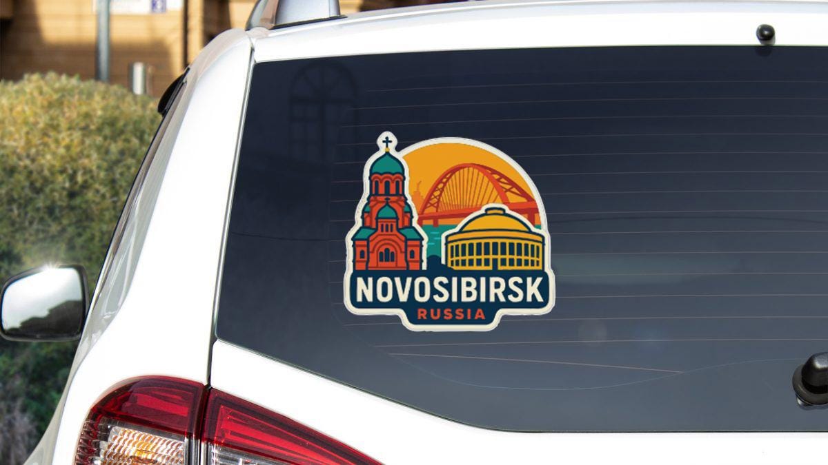 a sticker on the rear window of a car, depicting a city skyline with a church and a bridge.