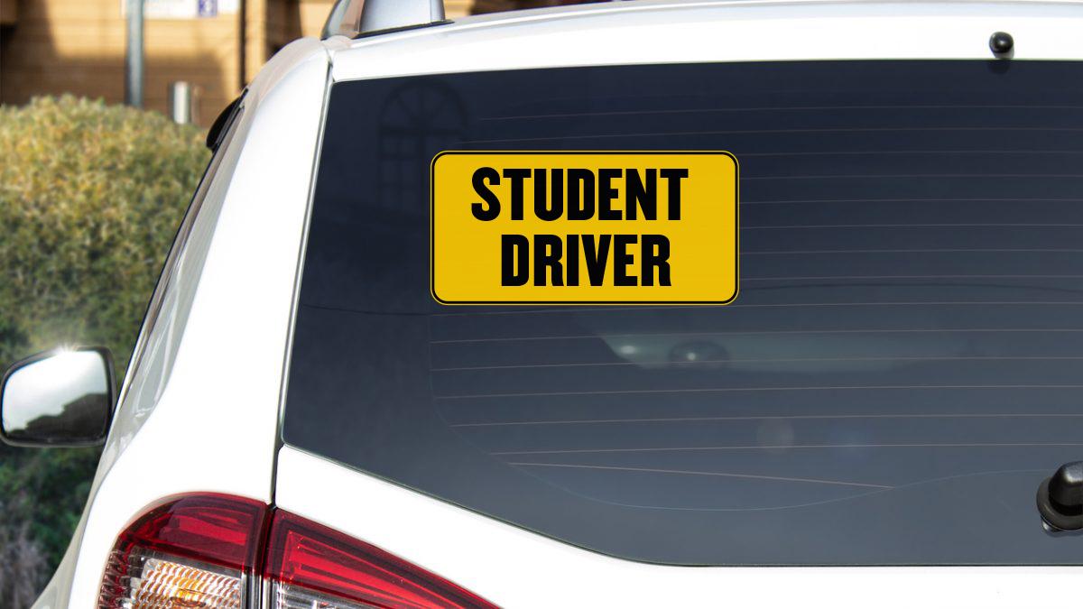 a yellow student driver sticker on the back of a car