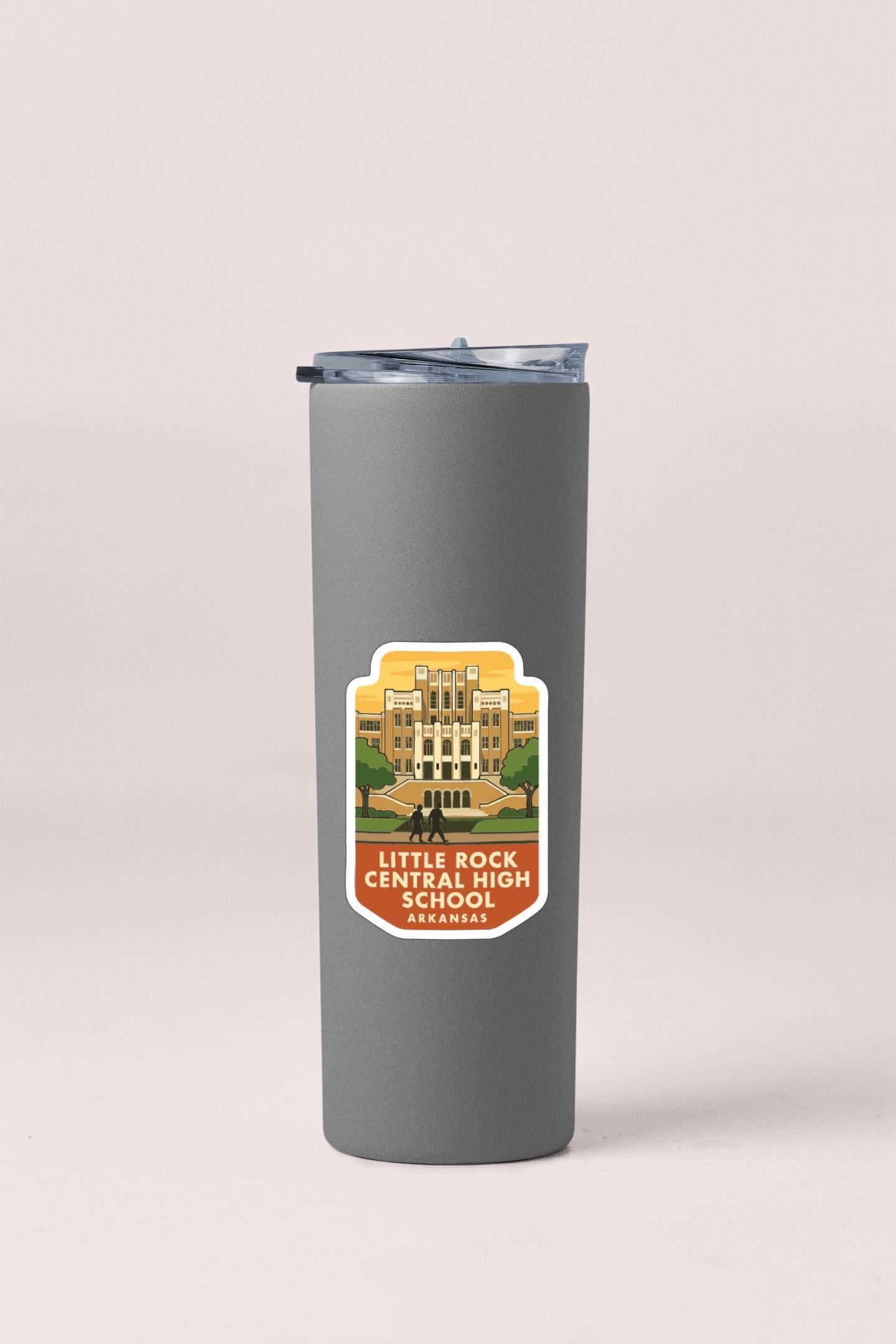 A gray insulated tumbler with a label that features an illustration of a high school building and the text "Little Rock Central High School".