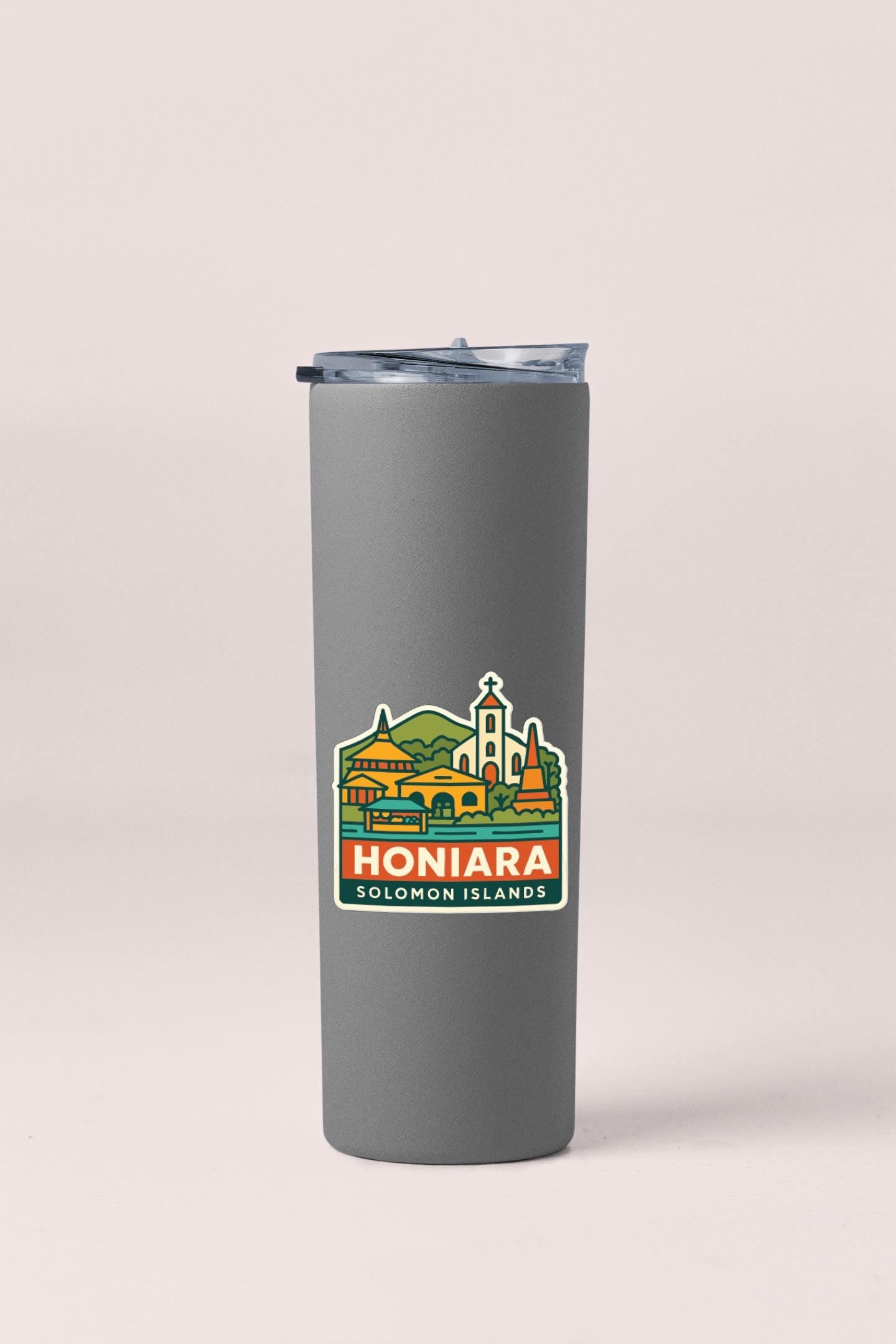 A gray insulated tumbler with a sticker depicting the town of Honiara, Solomon Islands.