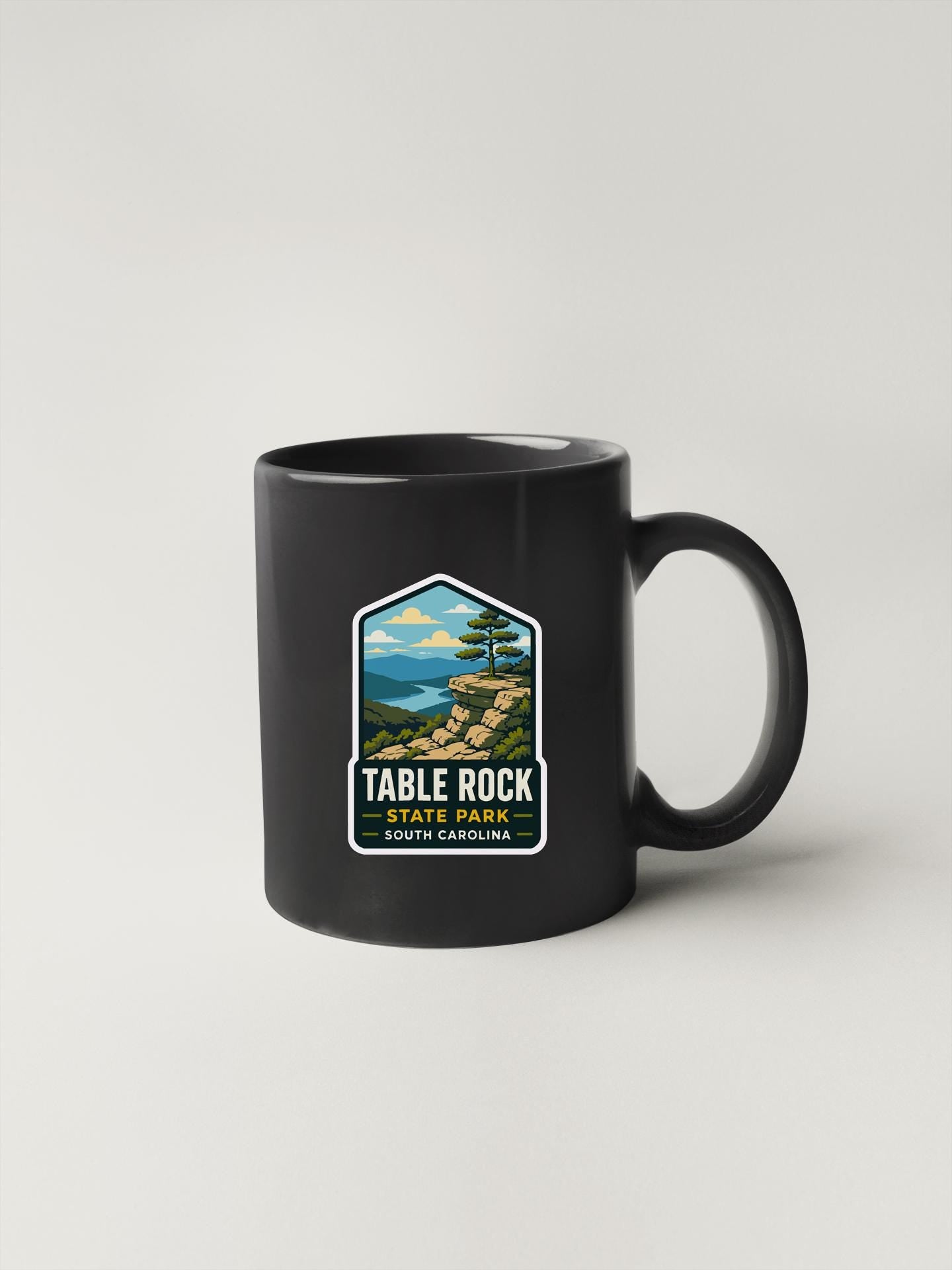 A black coffee mug with a label that says "TABLE ROCK STATE PARK SOUTH CAROLINA".