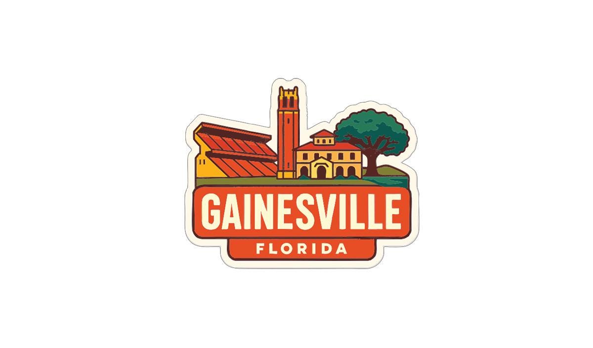 A sticker depicting the city of Gainesville, Florida, with a tall tower and buildings in the background.
