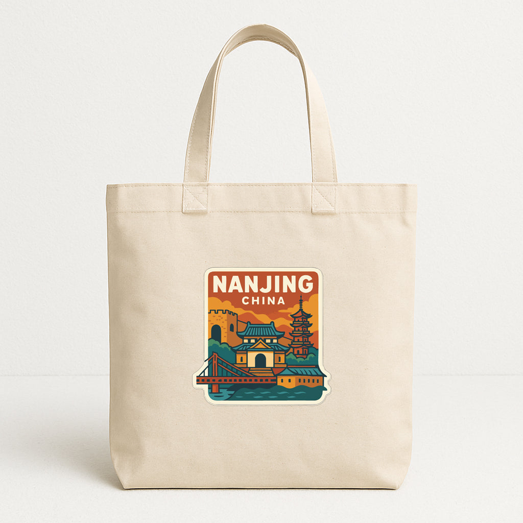 A beige tote bag with a printed design depicting a cityscape and landmarks, including a pagoda and a bridge, along with the text "NANJING CHINA".