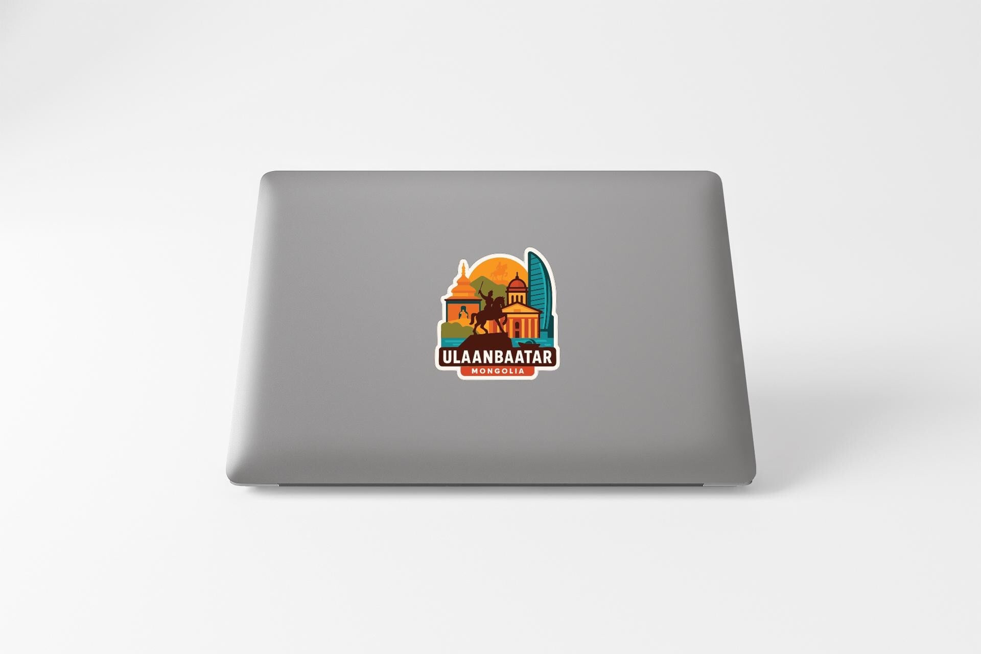 a sticker with a colorful illustration of a building and a horse, along with the text "ULAANBAATAR" and "MONGOLIA" printed on it.