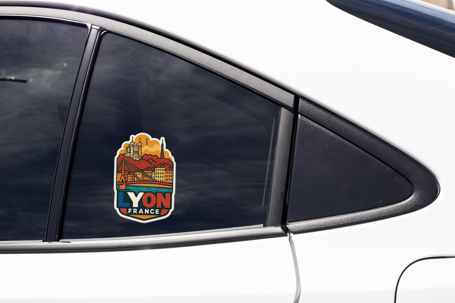 A sticker on the side of a car window, featuring a cityscape and the text "YON FRANCE".
