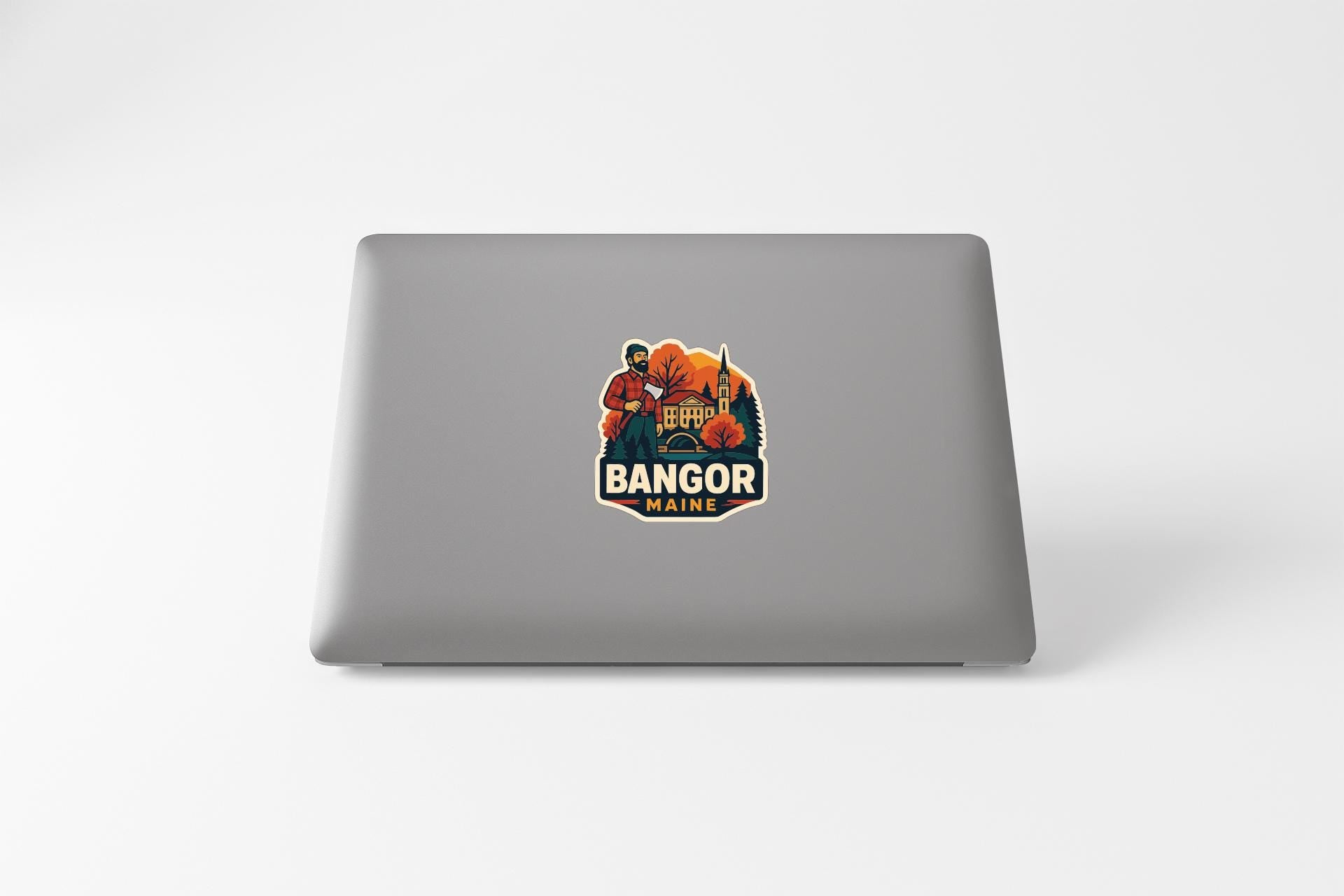 a sticker or decal on the back of a laptop, depicting a person in a red shirt and a building with a flag.