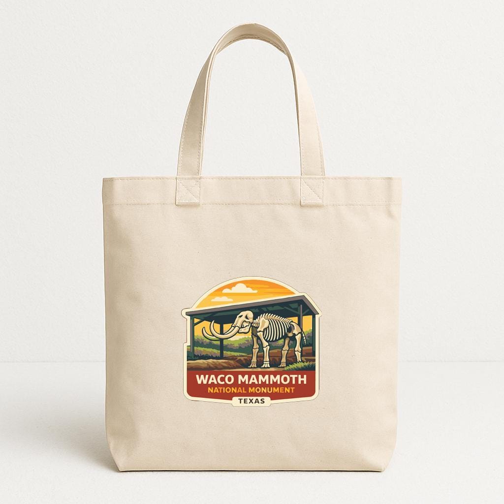 A beige tote bag with a printed design featuring an elephant and the text "Waco Mammoth National Monument, Texas".