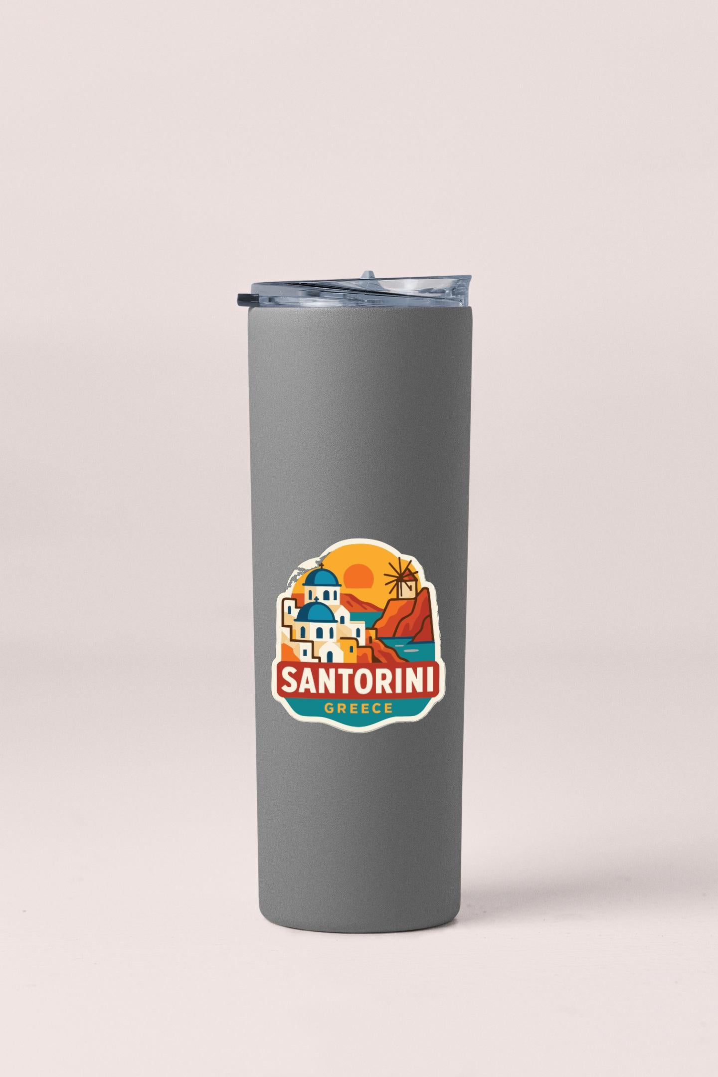 A gray insulated tumbler with a logo depicting Santorini, a Greek island.