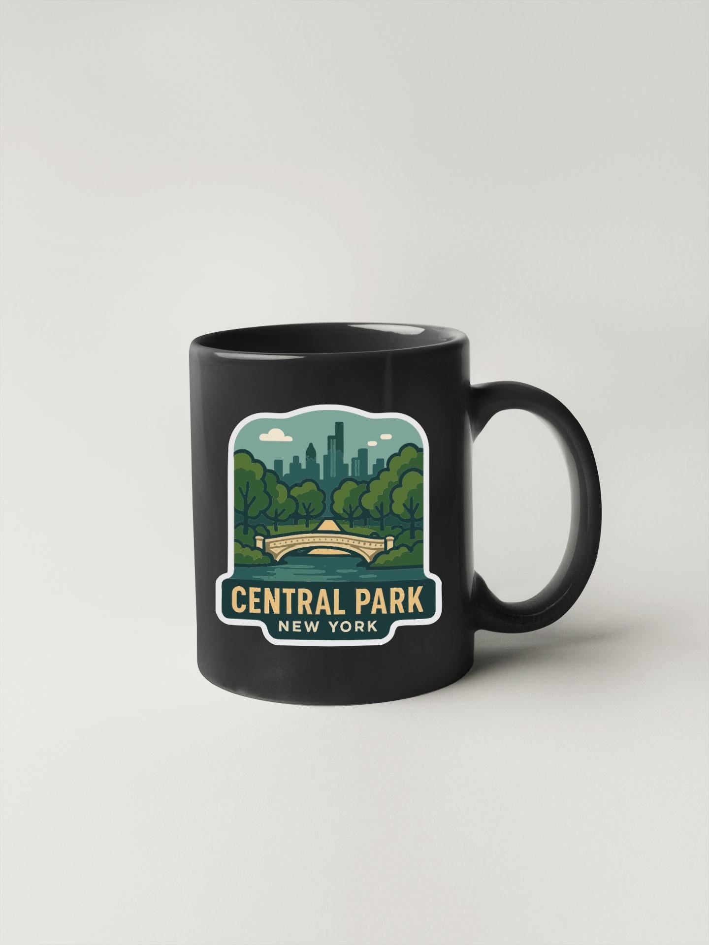 A black coffee mug with a graphic design depicting Central Park in New York.