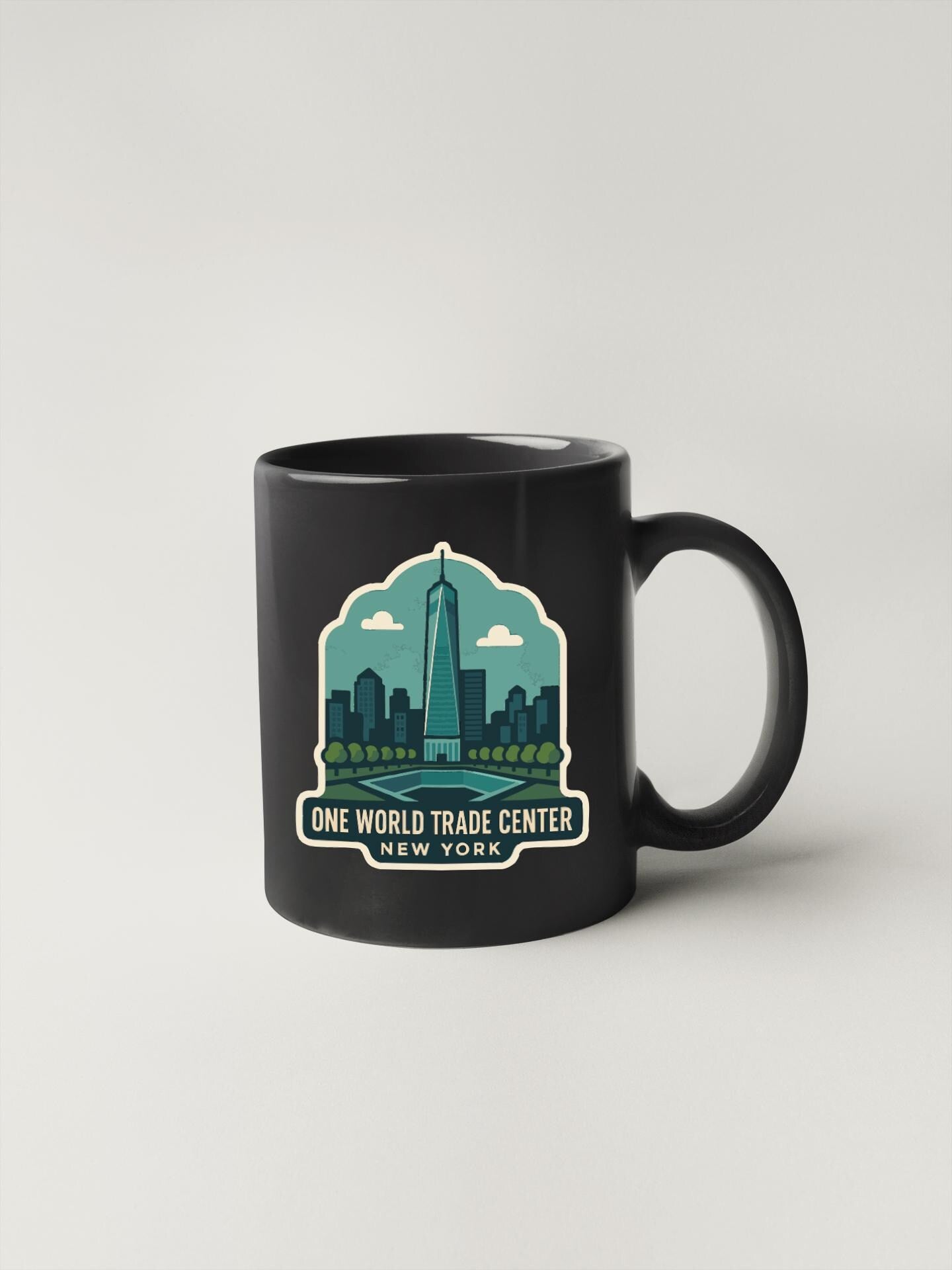 A black coffee mug with a graphic design depicting the One World Trade Center in New York.