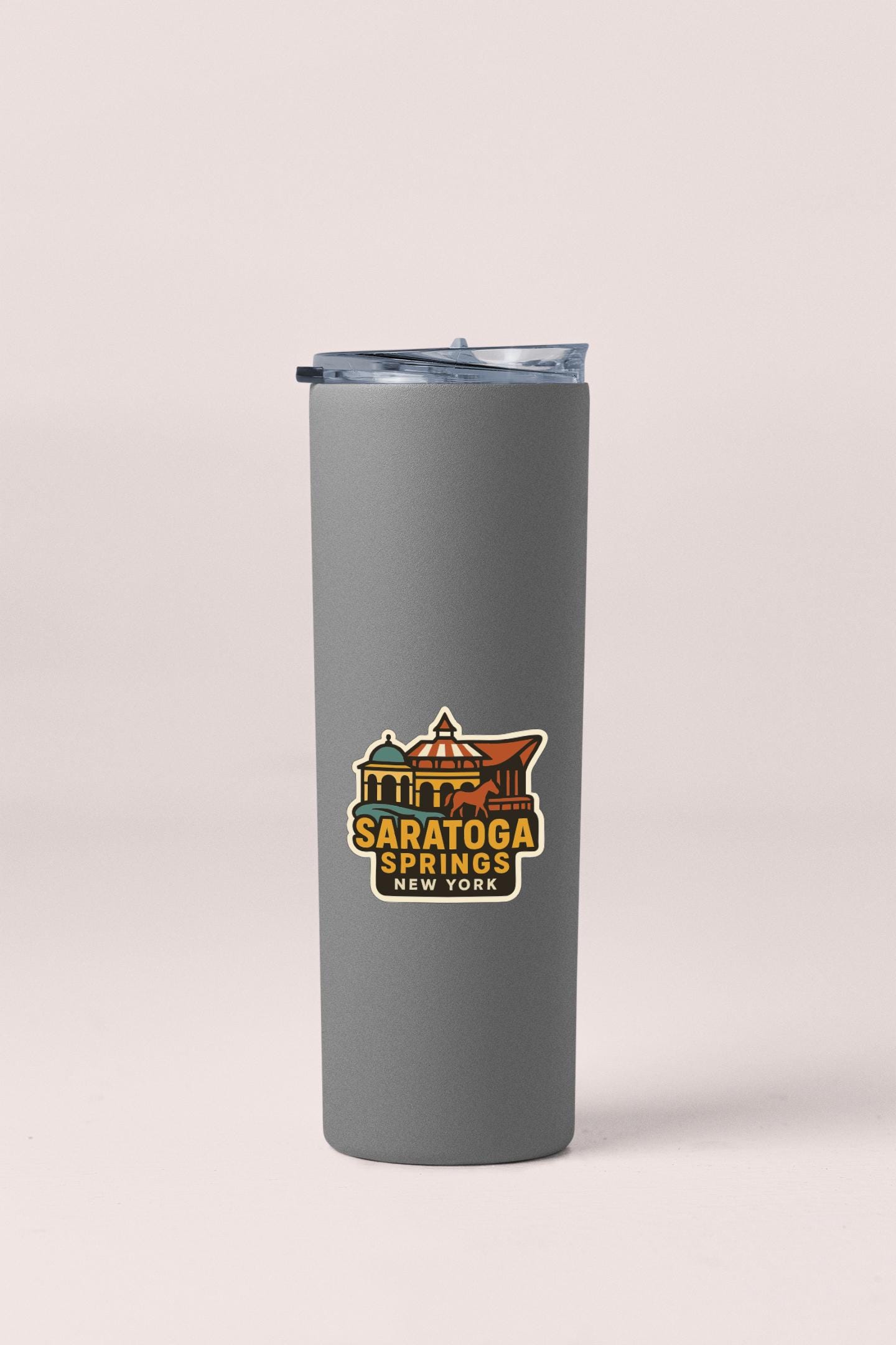 A gray insulated tumbler with a printed label that says "Saratoga Springs, New York".