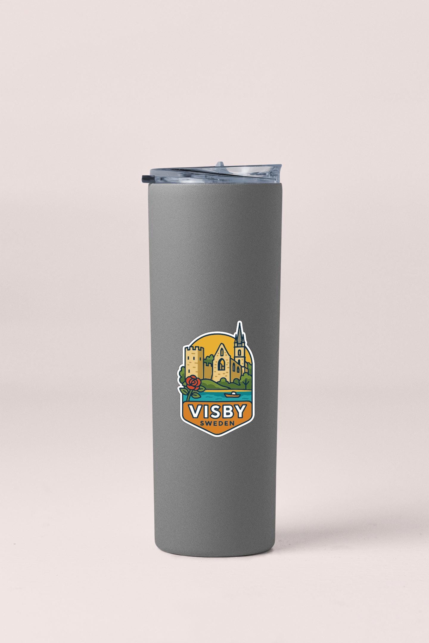 A gray insulated tumbler with a lid and a logo depicting a castle and a church.
