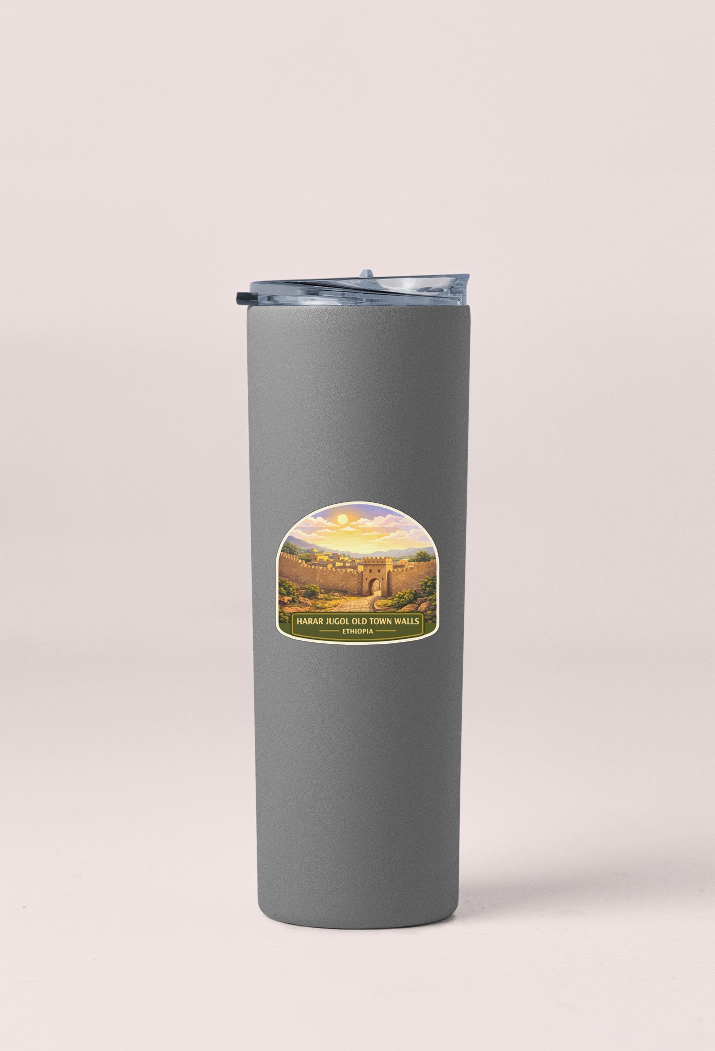 A gray insulated tumbler with a label featuring a scenic landscape.