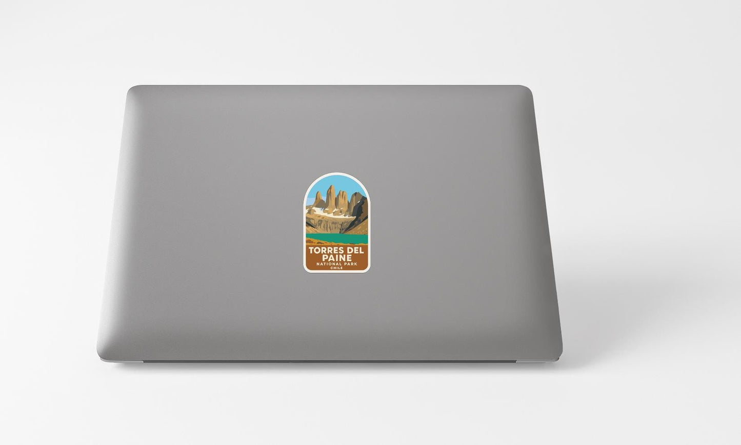 A sticker with a mountain landscape on a laptop.