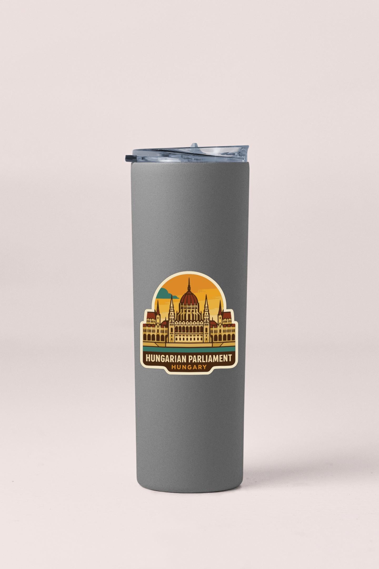 A gray insulated tumbler with a sticker depicting the Hungarian Parliament building.