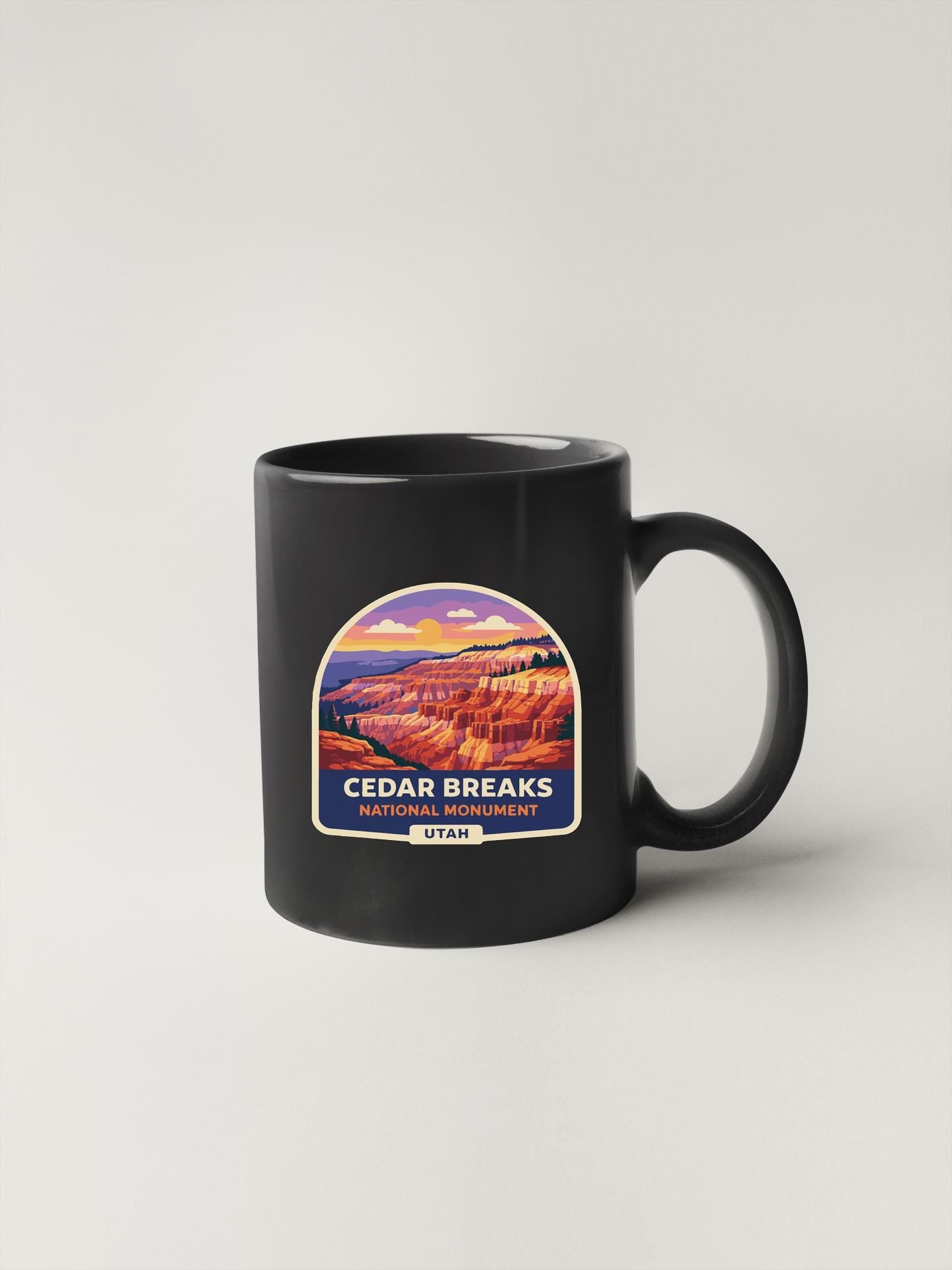 A black coffee mug with a label that says "Cedar Breaks National Monument Utah".