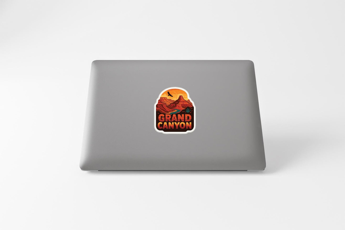 A sticker on the back of a laptop that says "GRAND CANYON".