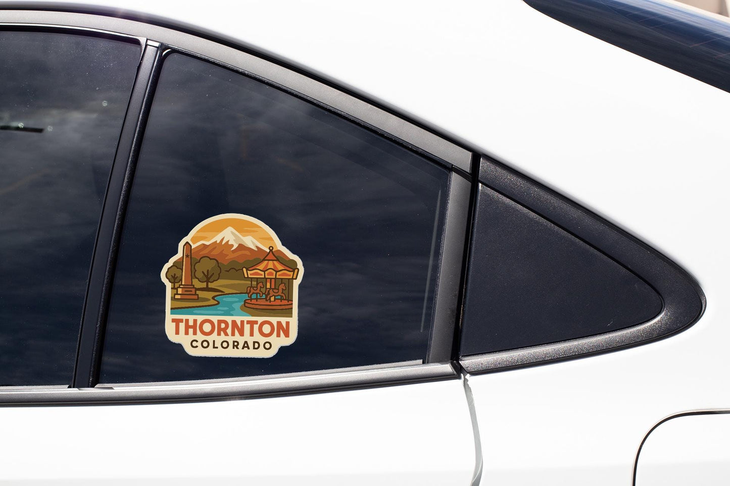 A car window sticker with a scenic mountain landscape and the text "THORnton COLORADO".