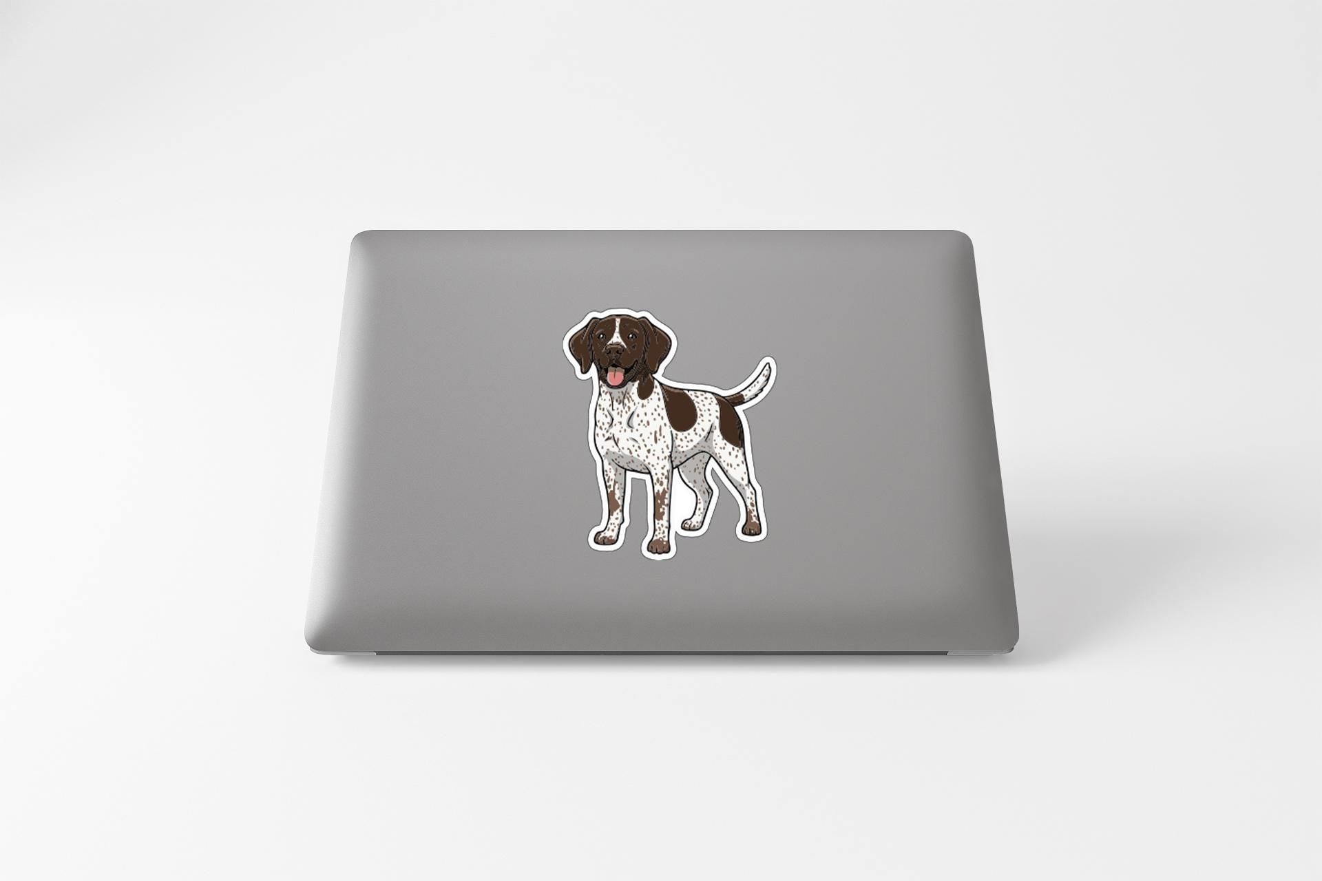 A sticker of a dog is placed on the back of a laptop.