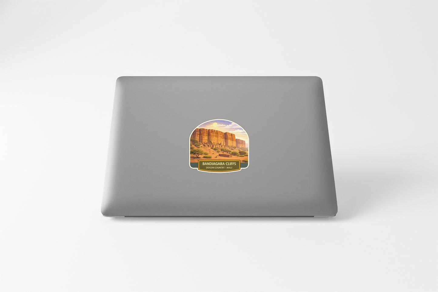 a sticker of a desert landscape on the back of a laptop computer.