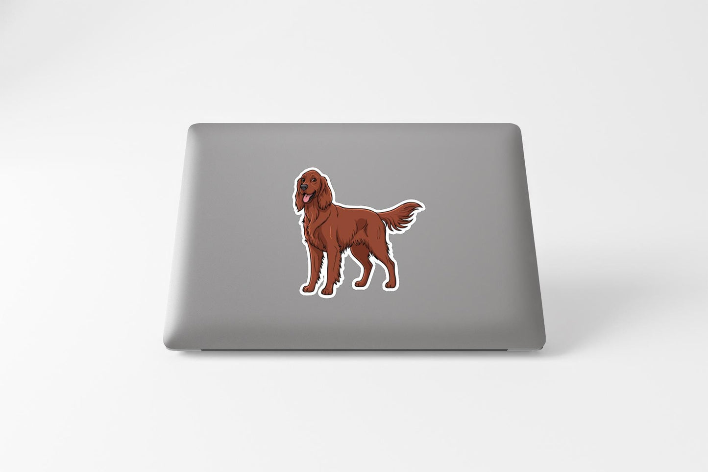 a sticker of a brown dog on the back of a laptop.