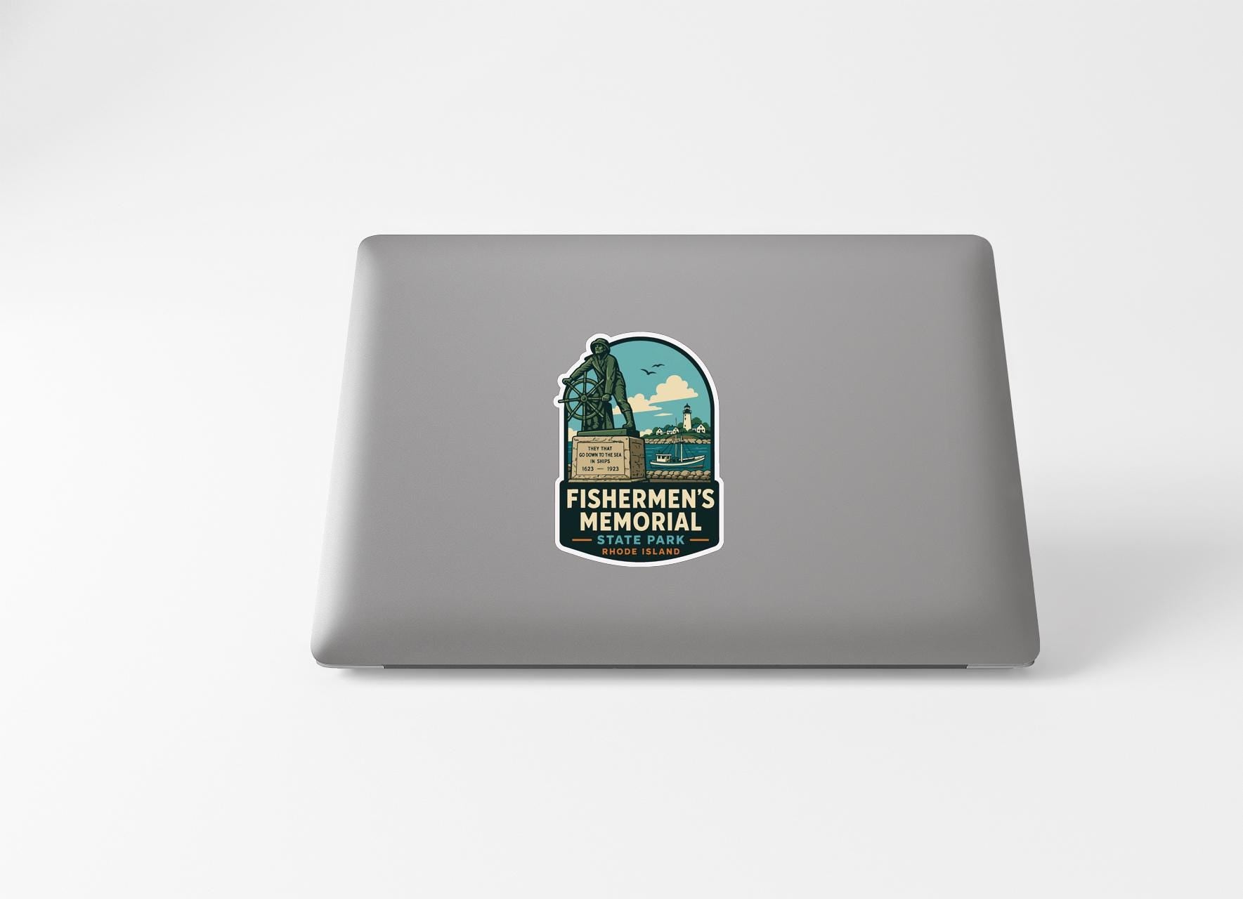 a sticker with a graphic of a monument or memorial, placed on the back of a laptop computer.
