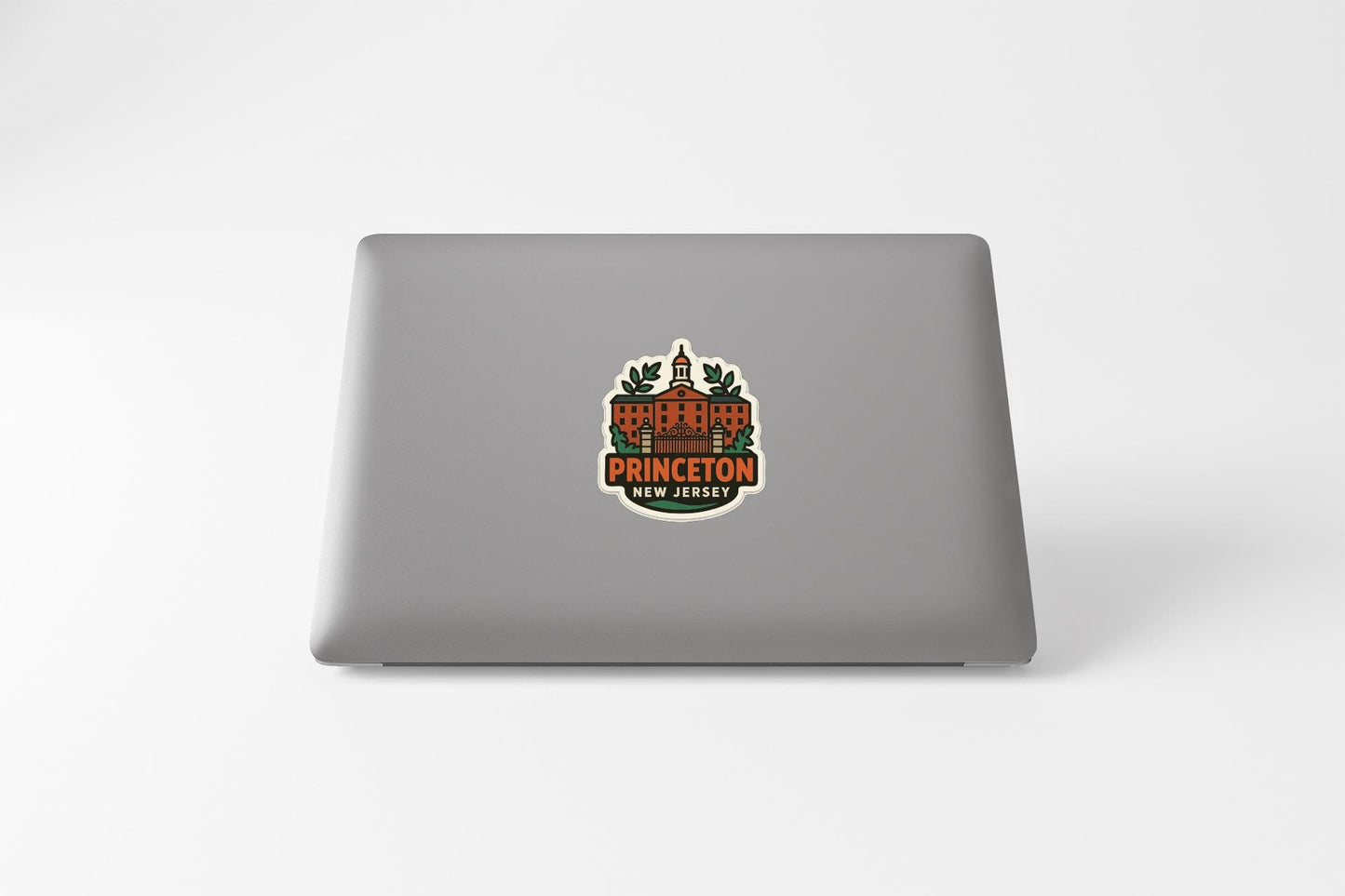 a sticker with a building and the text "Princeton" on a laptop.