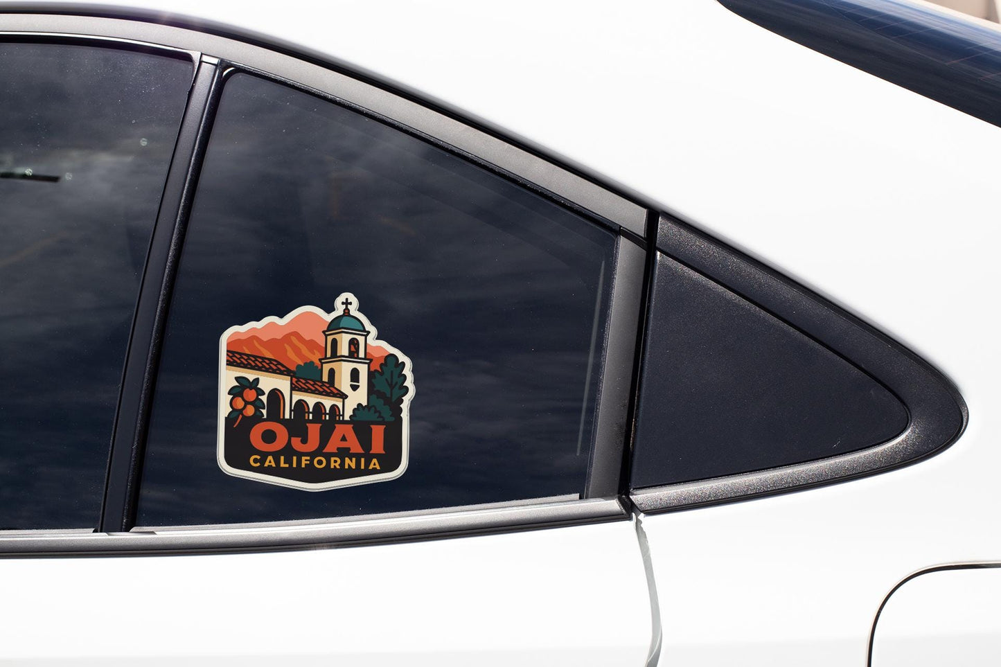 A sticker on the side of a car window, depicting a scenic view of Ojai, California.