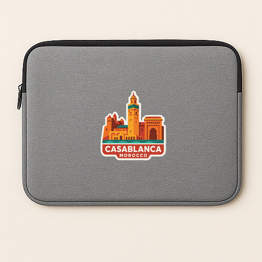 a gray laptop sleeve with a sticker of Casablanca, Morocco, printed on it.