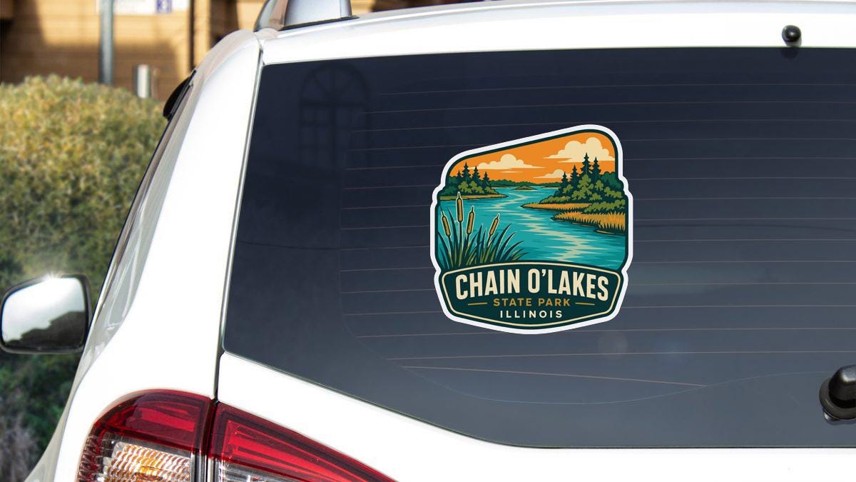 a sticker on the rear window of a vehicle, depicting a scenic landscape with a river and trees.