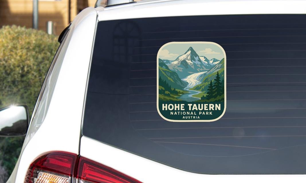 A sticker on the rear window of a car that says "HoeTAUERN NATIONAL PARK AUSTRIA".