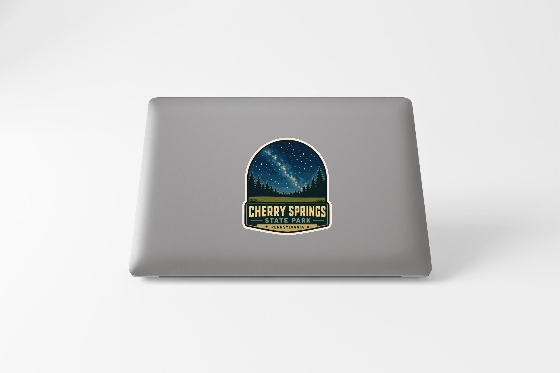 a sticker on the back of a laptop that says "CHERRY SPRINGS".