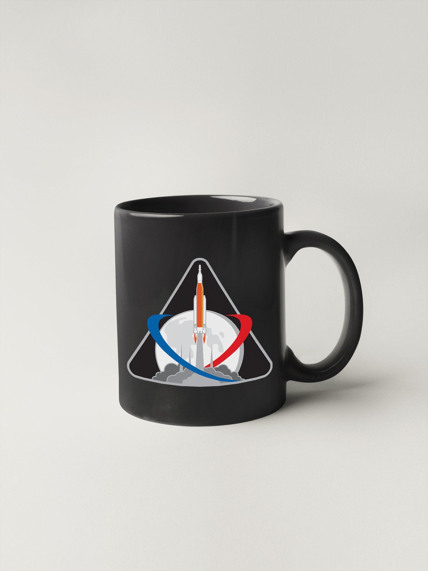 a black coffee mug with a picture of a pencil in it
