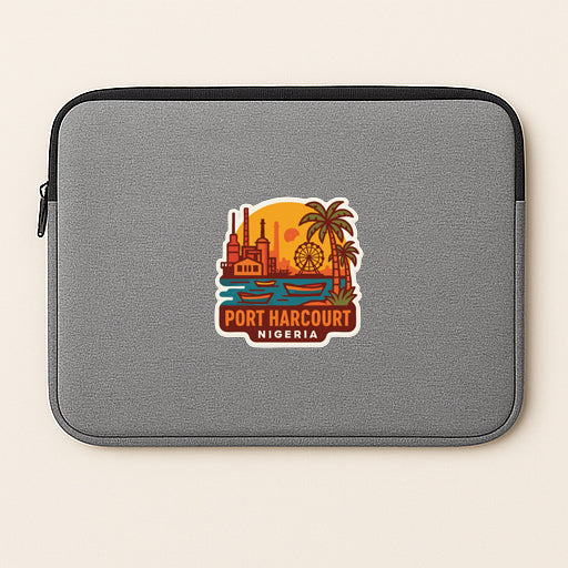 A gray laptop sleeve with a sticker depicting the Port Harcourt, Nigeria cityscape.
