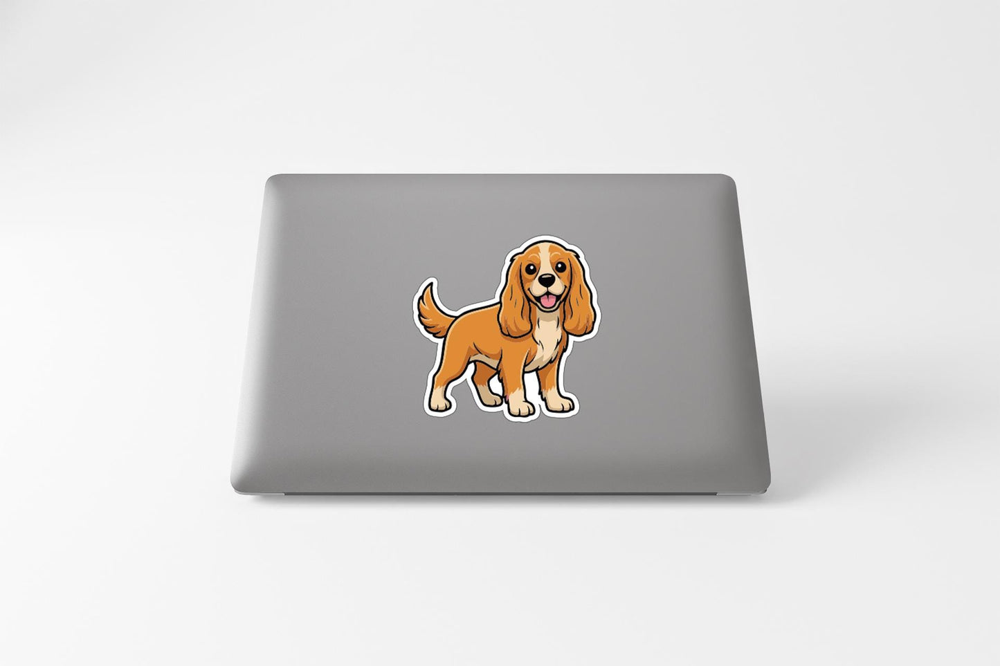 A cartoon image of a dog is displayed on the back of a laptop.
