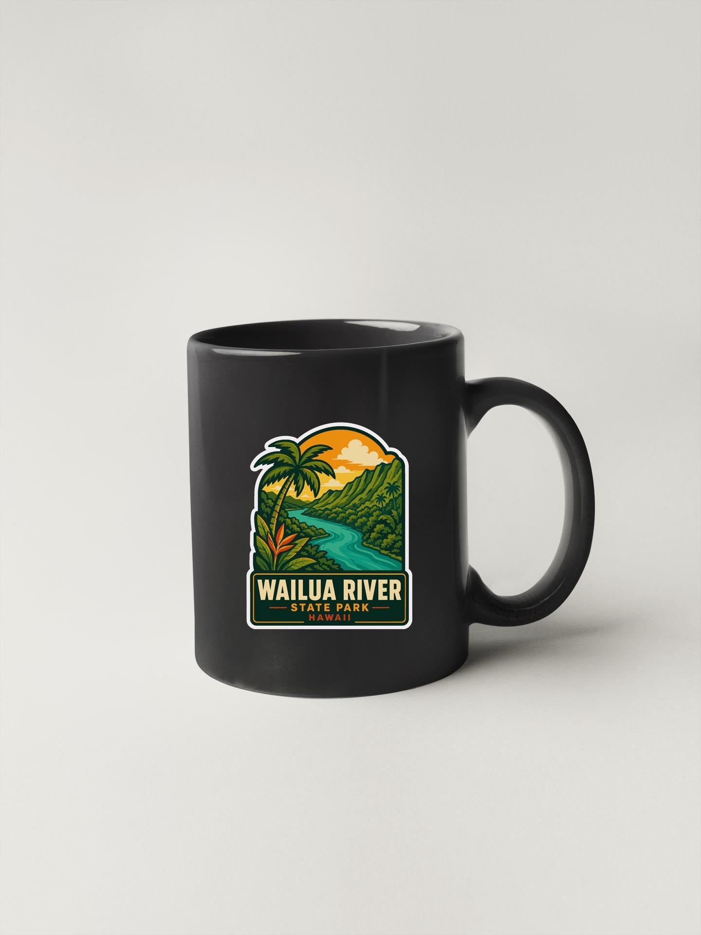 A black coffee mug with a colorful graphic depicting a tropical landscape, including palm trees, a river, and mountains.