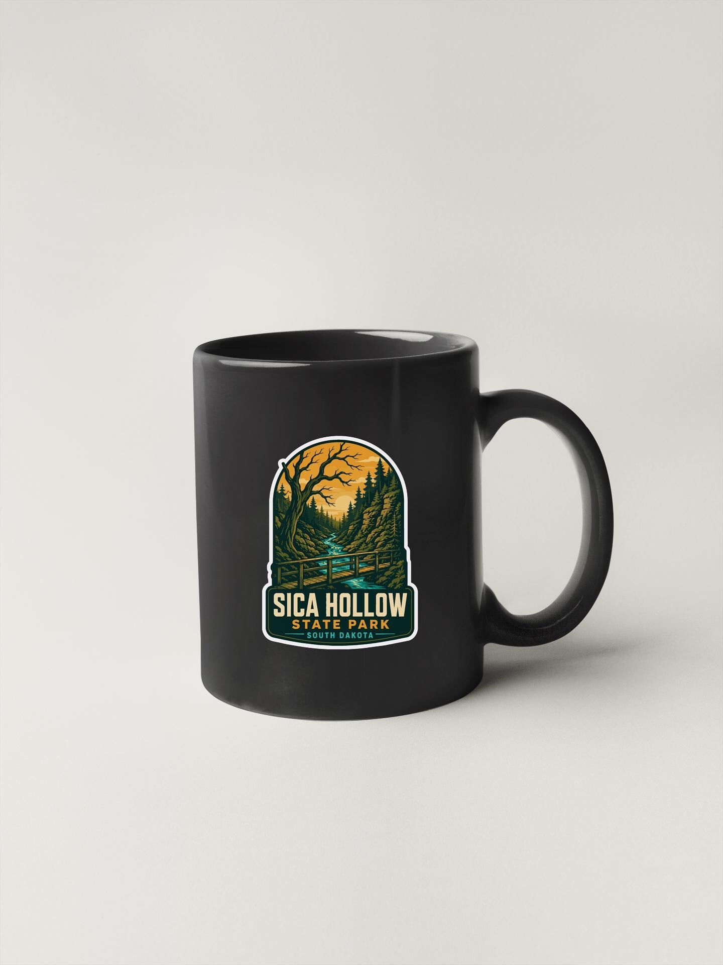 A black coffee mug with a graphic design depicting a forest scene and the text "SICA HOLDOW STATE PARK SOUTH CAROLINA".
