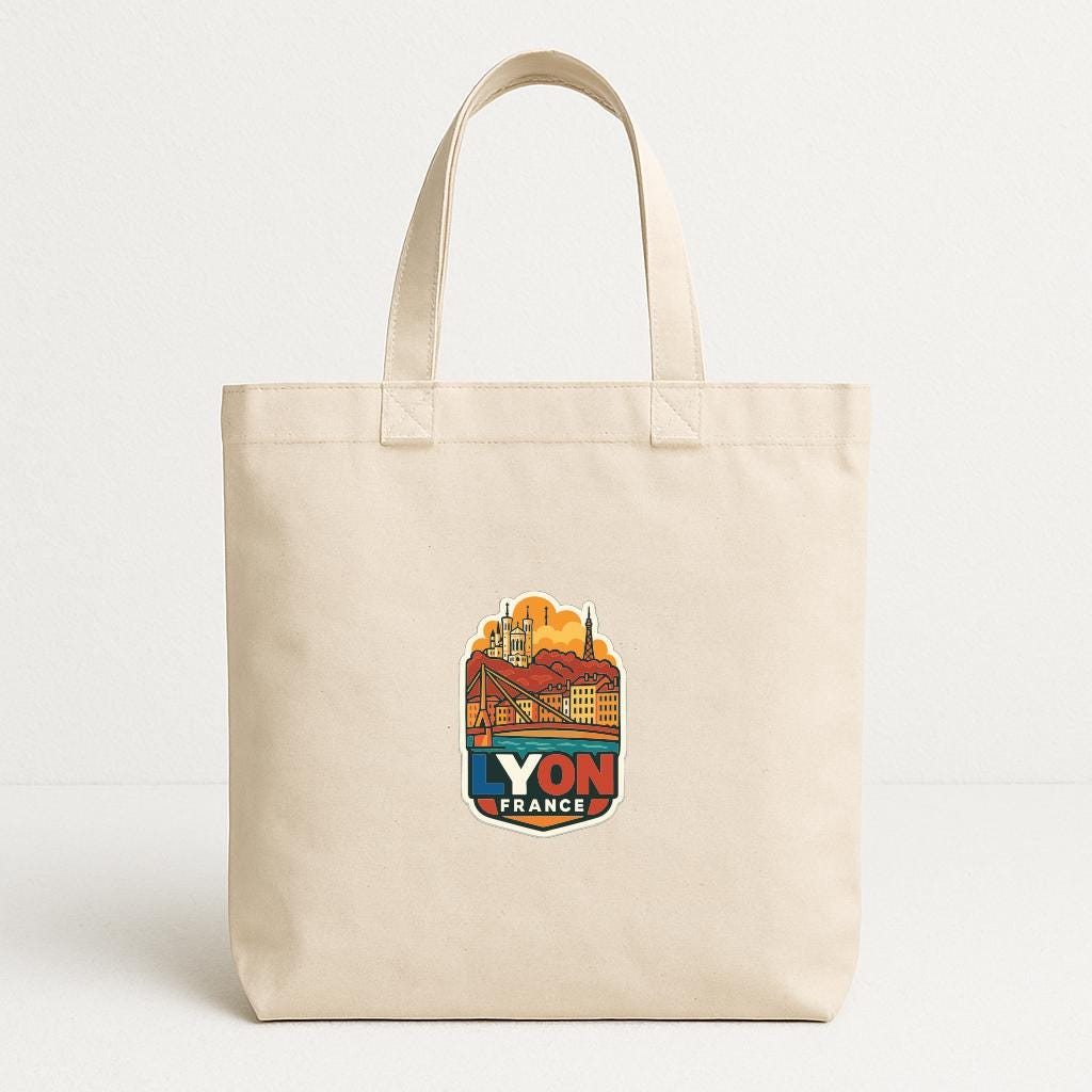 A beige tote bag with a colorful sticker depicting a cityscape and the text "YON FRANCE" printed on it.