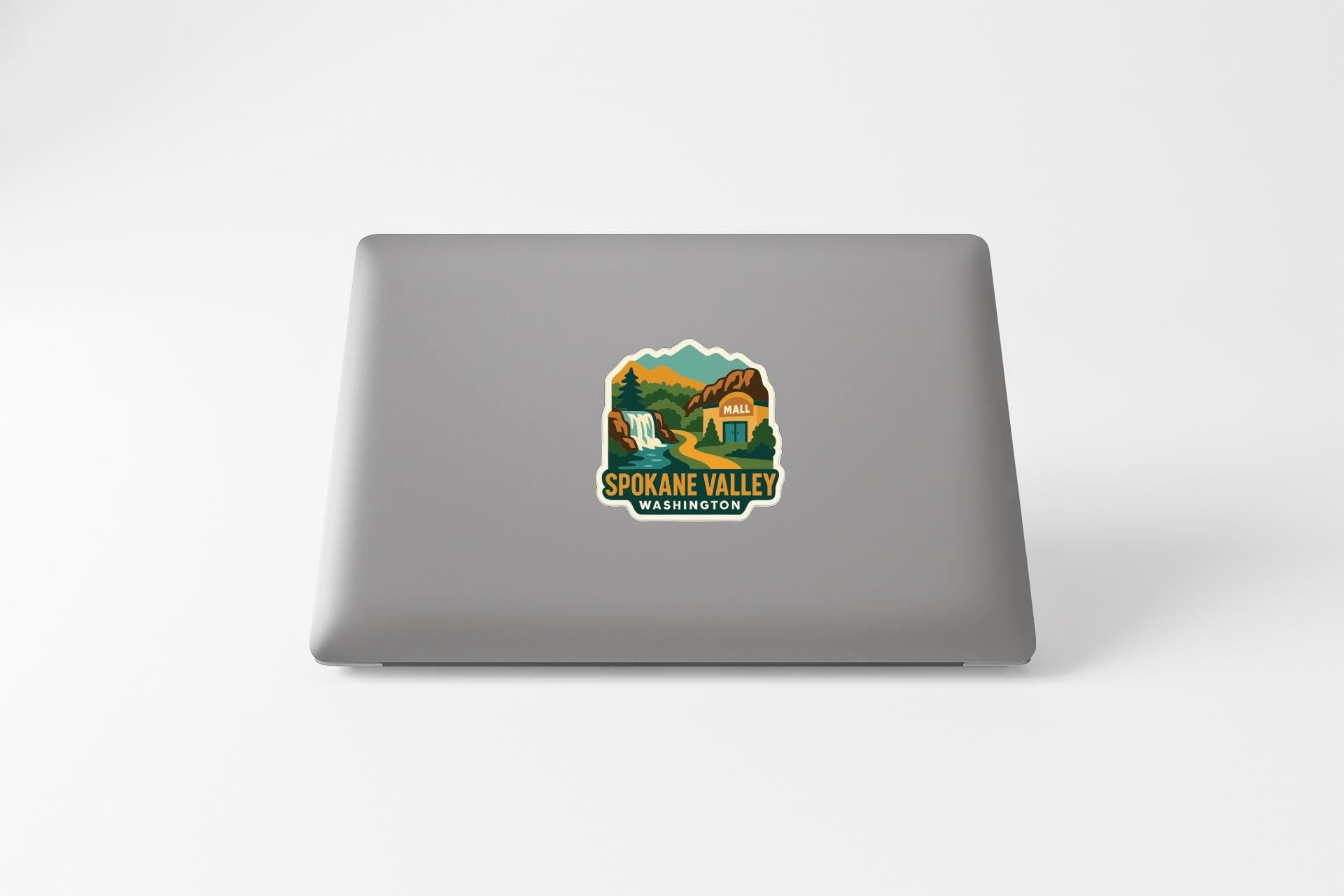 a sticker on the back of a laptop that says "SPOKANE VALLEY WASHINGTON".