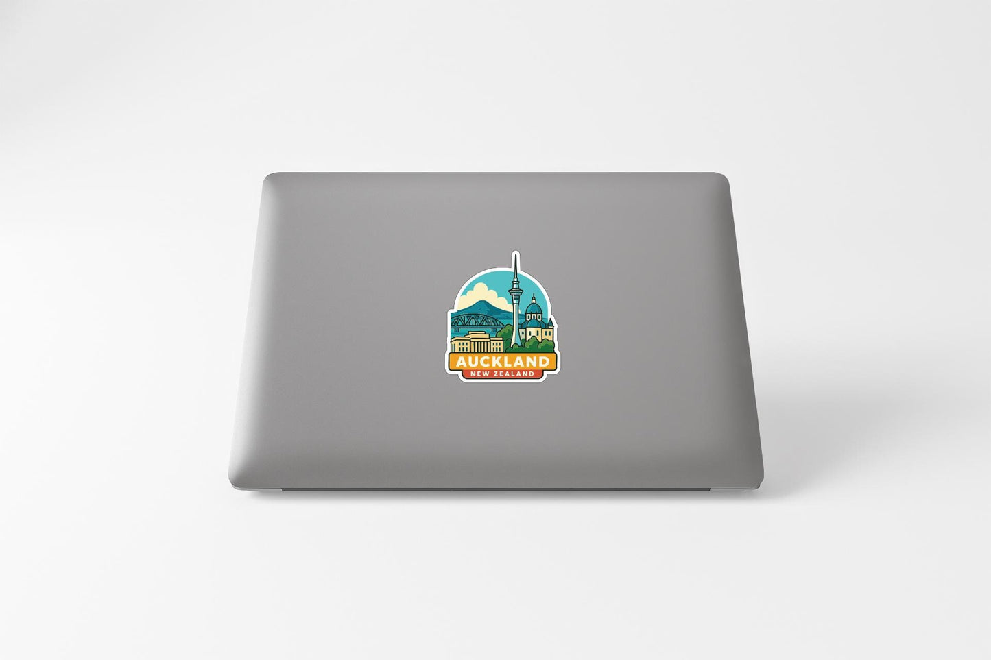 a sticker of the Auckland Tower on the back of a laptop.